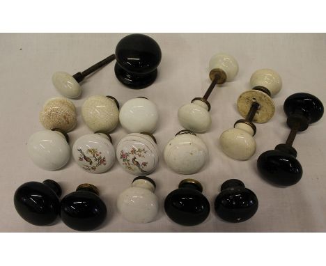 A quantity of 19th / 20th century ceramic door knobs in black and cream