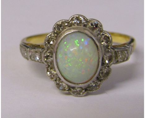 18ct gold and platinum ring with central opal and diamond chips (diamond total 0.25 ct) total weight 3.9 g size R/S