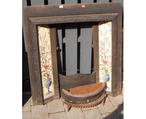 An Art Nouveau influence black painted cast iron and tile inset fire surround, with integral fire grate, 97 x 92cm