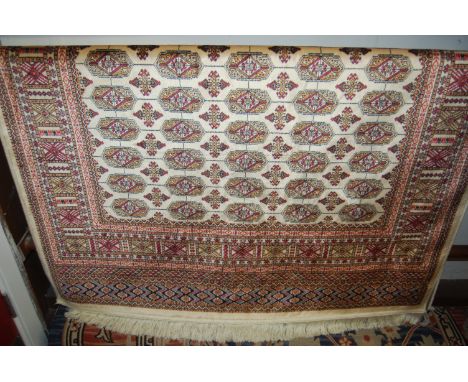 A modern Persian cream ground Bokhara carpet, 190 x 140cm