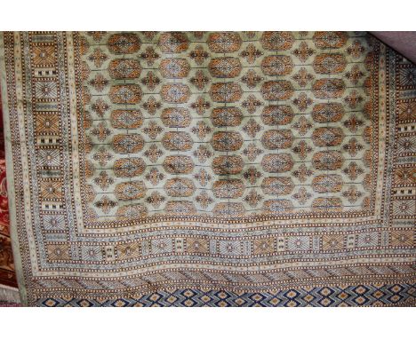 A modern Persian green ground Bokhara carpet, 230 x 160cm