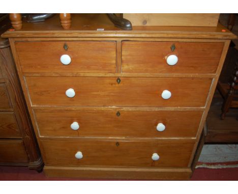 A Victorian pine chest of two short over three long drawers, having glazed ceramic handles and later applied plyboard top, wi