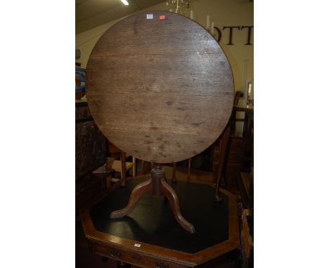 An early 19th century oak circular tilt top pedestal tripod table, dia. 85cm