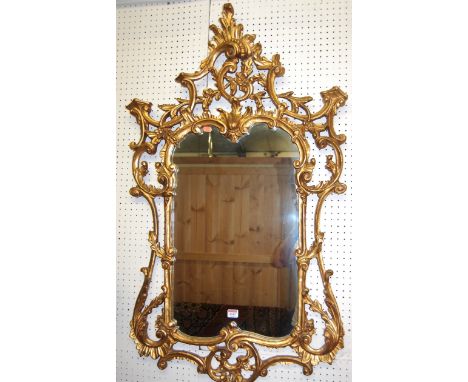A contemporary Chinese Chippendale style floral gilt decorated shaped wall mirror, 117 x 68cm