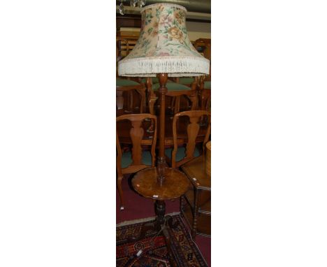 A figured walnut standard lamp, with piecrust shaped central platform 