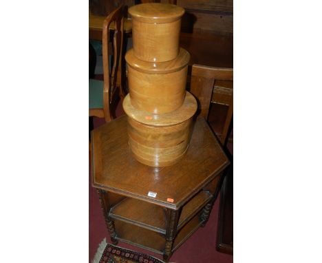 An early 20th century hexagonal oak book table, having part bobbin turned supports; together with a graduated set of three ci
