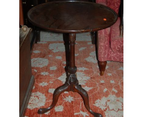 A 19th century mahogany circular tilt top pedestal tripod table raised on acanthus leaf carved and hipped supports, dia. 55.5