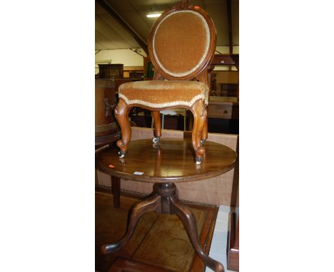 A Victorian figured walnut child's nursing chair having upholstered pad back and seat, together with a low circular pedestal 