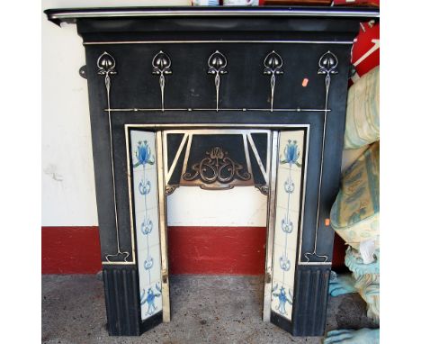 A contemporary Liberty Art Nouveau style cast iron and tile inset fire surround, with raised marks verso, 118 x 107cm