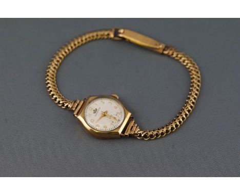 A yellow metal wristwatch having a circular white dial, signed Marvin. Seventeen jewelled manual wind movement. Inner case ha