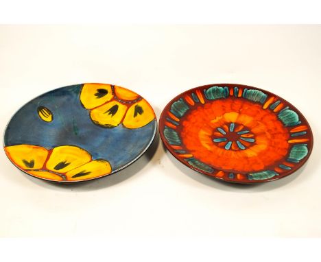 Two brightly decorated Poole pottery chargers,40cm diameter
