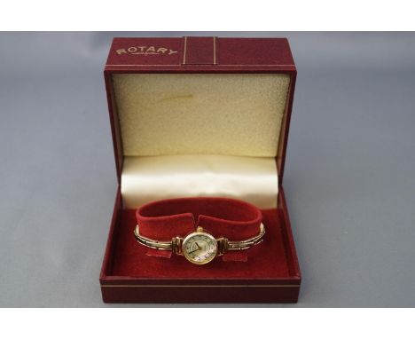 A yellow metal wristwatch by Rotary. Mother of pearl dial with Arabic numerals. Six jewelled quartz movement, ETA reference 9
