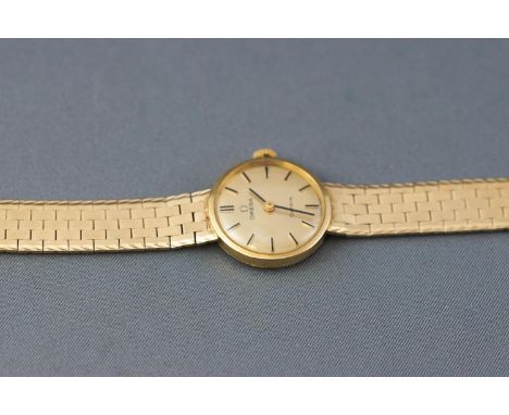 A yellow metal wristwatch by Omega. Seventeen jewelled manual wind movement, signed Omega, calibre 620. Case reference: 51129