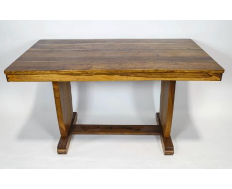 An African walnut dining table, 76cm high x 137cm wide x 83cm deep and a matching set of four ladder back chairs, 