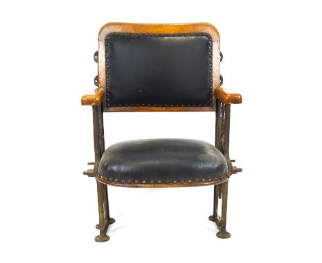 An early 20th century oak framed cinema chair, with metal side construction and green leather folding seat and back, with woo