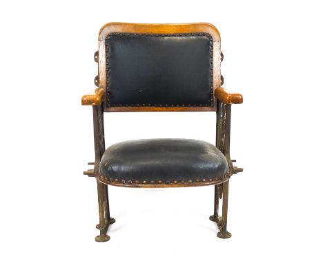 An early 20th century oak framed cinema chair, with metal side construction and green leather folding seat and back, with woo