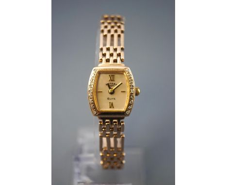 A yellow metal Rotary elite wristwatch. Mother of pearl dial with diamond set bezel. Quartz movement. Fitted to a yellow gold