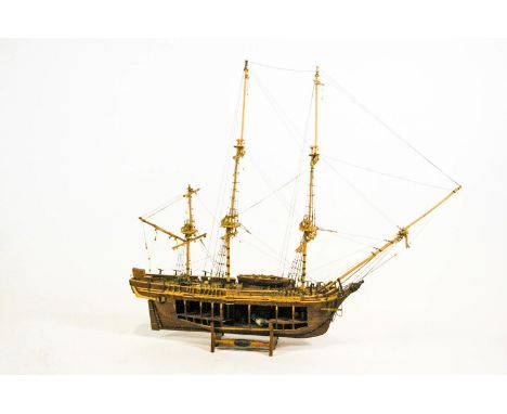 A cut-away wood scale model of HMS Bounty on stand, 68cm long