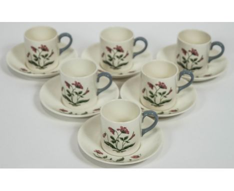 A Wedgwood 'Mayfield' coffee set for six, with cups, saucers and plates, all with flowering motifs in a grey border