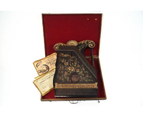 A cased 19th century Zither, labelled the Harp Co, Merkur, Conzert -Guitar Zither, in ebonised wood decorated with floral mot