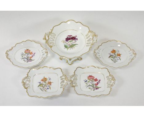 A 19th century part dessert service, printed and painted with specimen flowers in a gilt highlighted surround with pierced ha