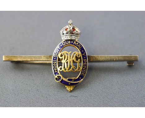 A yellow and white metal royal horse guards bar brooch. Blue and red enamel finish with a single cut diamond crown. Pin and r