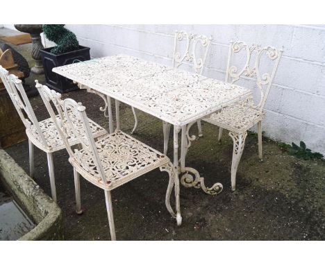 A rectangular cast metal garden table with pierced foliate decoration together with four similar chairs, table 72cm high x 11