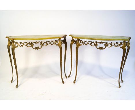 A pair of onyx topped console tables, the shaped tops on gilt metal open pierced bases with cabriole supports, 75cm high x 91