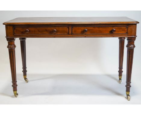 A mid 19th century mahogany writing table with rounded corner rectangular top over a plain frieze set with two long drawers w