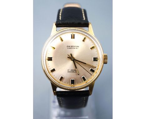 A gold plated wristwatch by J W Benson. Silver circular dial with baton markings. 17 jewelled manual wind movement. Black lea