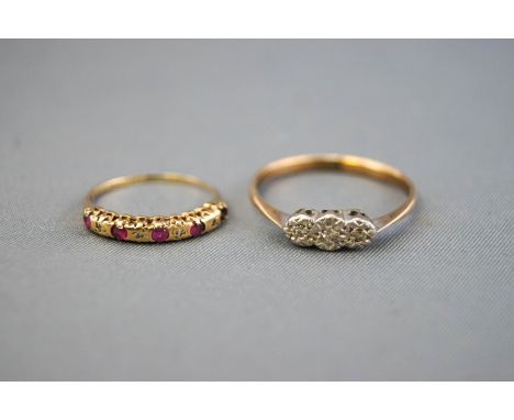 A collection of two dress rings to include: A yellow and white metal illusion set three stone diamond ring, size T; A yellow 