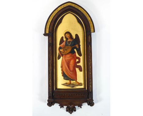 A 19th century Italian gilt gesso wood panel, depicting an Angel playing a lute, contained within a carved wood and gilt Goth