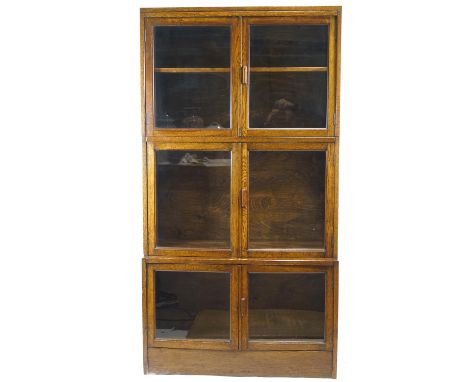 An early 20th Century oak glazed triple bookcase in the Globe Wernicke style, each section with glazed double doors, 162cm hi