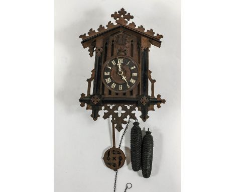 An early 20th century cuckoo clock, Gothic numerals, pine cone weights, height 47cm