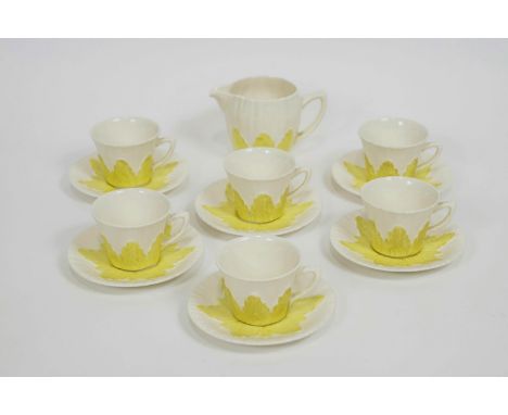A Solian ware coffee set with six cups and saucers and a jug, decorated with yellow foliate motifs, numbered 158, the jug 8cm