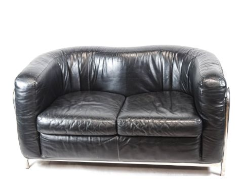 A Zinotla sofa with chrome frame enclosing a leather shaped back and cushion, 131cm wide x 81cm deep (overall)