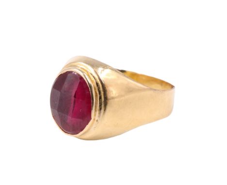 A mid 20th Century French ruby finger ring, having a faceted 9 x 7 mm oval ruby bezel set between tapering convex shoulders i