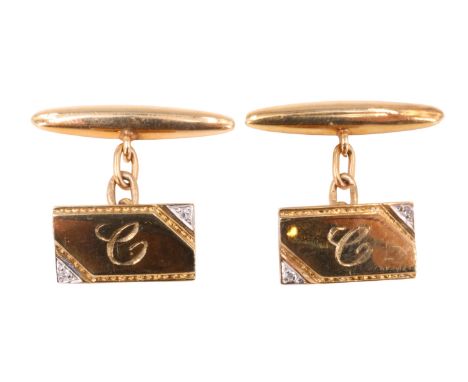 A pair of diamond and 9 ct yellow metal cufflinks, each having an oblong front with opposing corners in white metal set with 