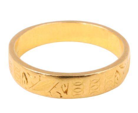 A 22 ct gold wedding band, of oblong section having engraved decoration, London, 1959, 3.86 g, size K/L, 4 mm wide