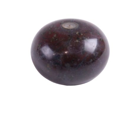 A Victorian variegated red marble paperweight having a diminutive inset compass, 6.5 cm diameter 