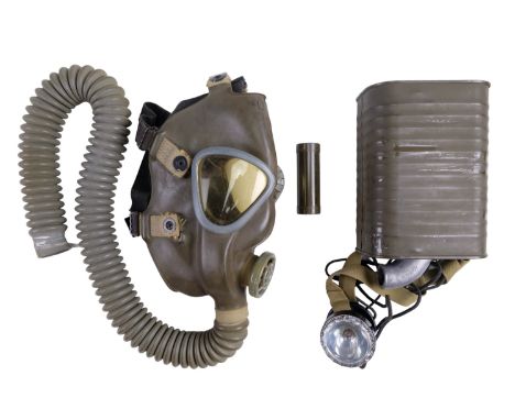 A Second World War US army gas mask together with a Signal Corps head torch and a tube of camouflage face paint