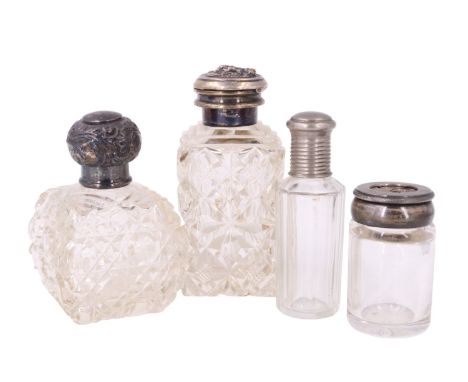 Two silver topped scent bottles and an electroplate mounted bottle, together with a 'diaphragm' topped cut glass dressing tab