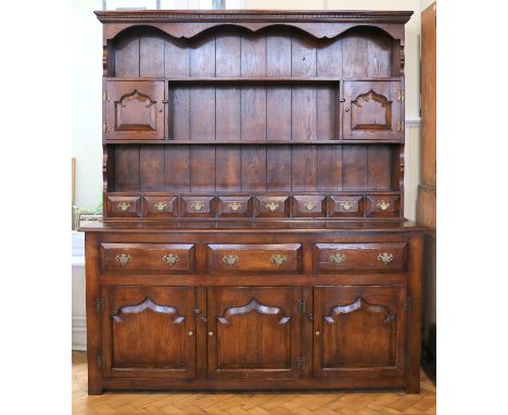 A late 20th Century Chapman's 'Siesta' oak dresser, having three drawers over cupboards and further cupboards and spice drawe