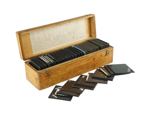 A Victorian pine magic lantern glass slide case together with a quantity of photographic and other slides covering a diverse 