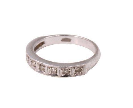 A late 20th Century diamond half hoop eternity ring, having nine brilliants, in pavé millegrain settings, on a shank marked '