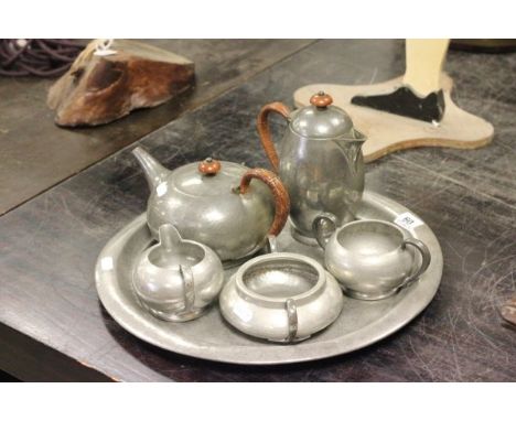 Liberty's & Co Tudric Hammered Pewter Tea Service comprising Circular Tray, Tea Pot, Coffee Pot, Milk Jug, and Two Sugar Bowl