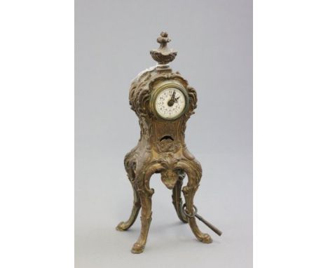 Ornate French Gilt Mantle Clock raised on four tall legs with enamel face with painted floral design and arabic numerals 