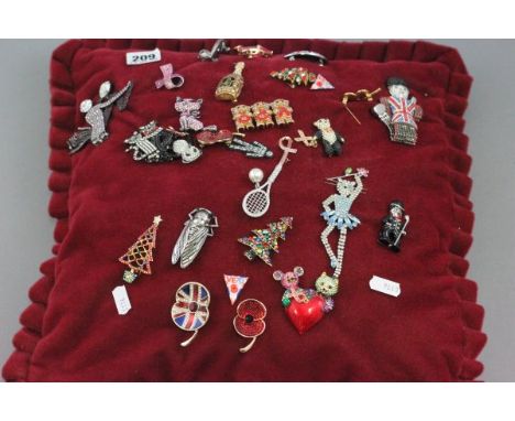 Approximately 25 Costume Jewellert Broohes pinned to a cushion