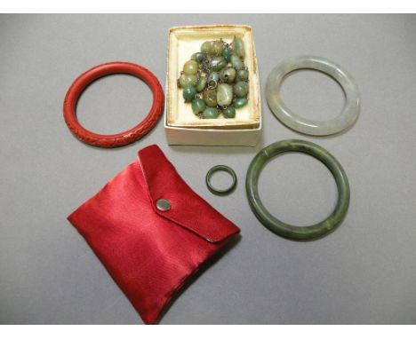 Collection of Stone Jewellery including Two Jade Bangles and a Ring, Cinnabar Effect Bangle, and a Stone Bead Necklace togeth