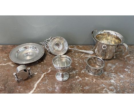 A Bachelor's breakfast service very fine silver eggcup (a), Armada dish (b), mug (c), tea strainer (d), napkin ring (e); and 